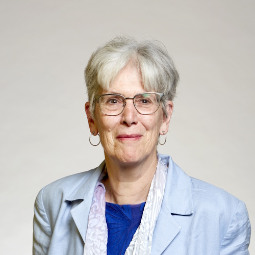 Dr Sandra Knapp FRS wearing a blue blazer against a grey background